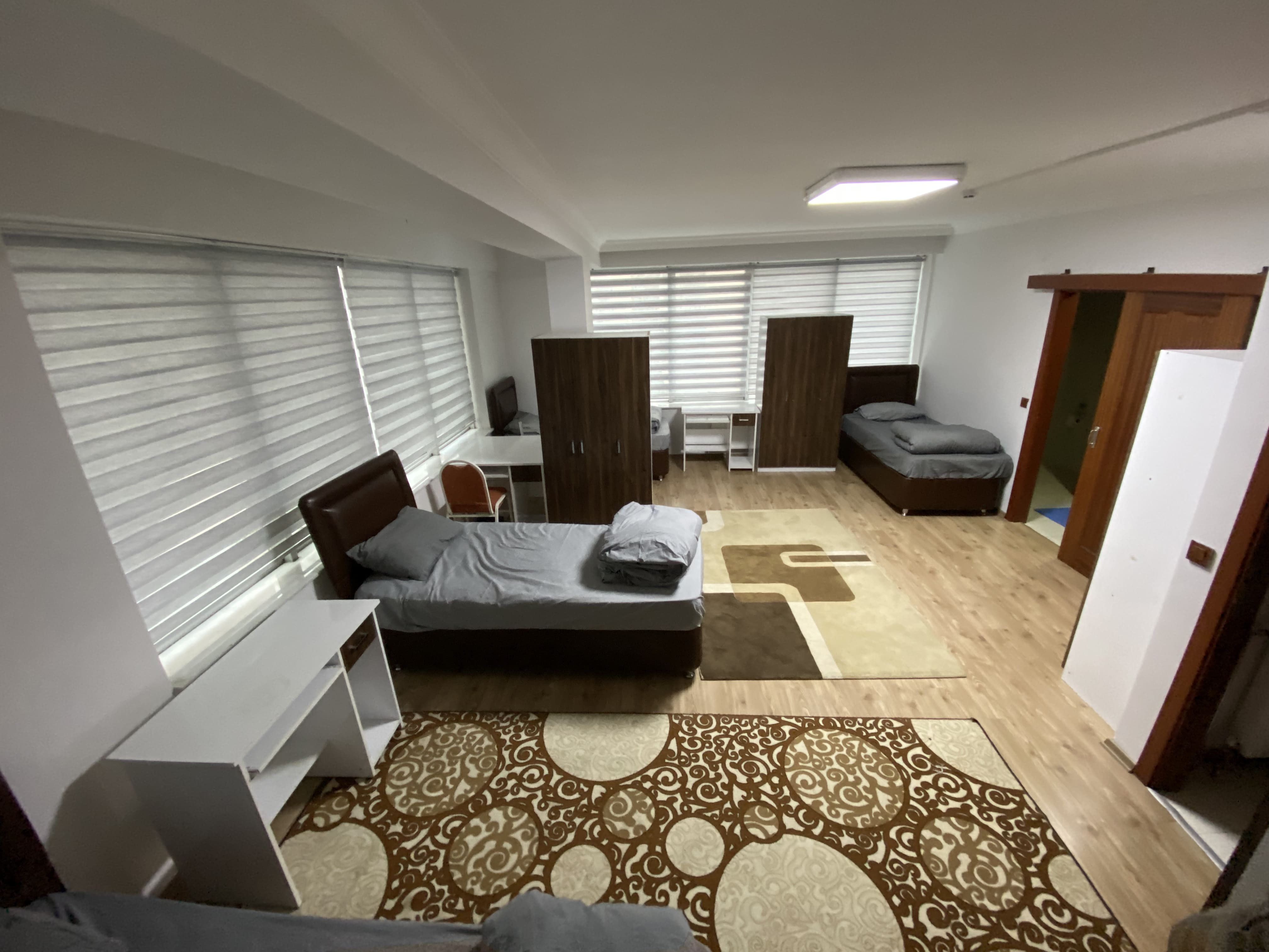 Quad room student housing - spacious 4-person dormitory accommodation with personal study areas, wardrobes, and modern amenities in Ankara